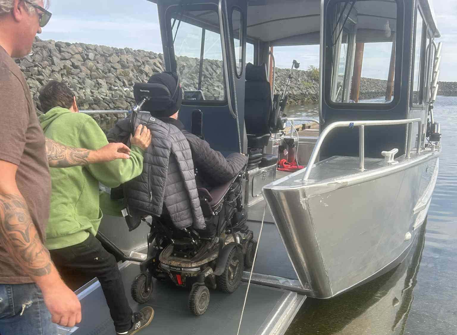 Wheelchair user boarding the boat via the accessible ramp at Discovery Harbour